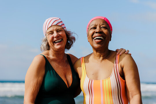 Senior women sharing laughter and joy at the beach