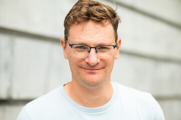 Obraz premium Portrait of a 45 yo white man against a grey wall, Brussels, Belgium