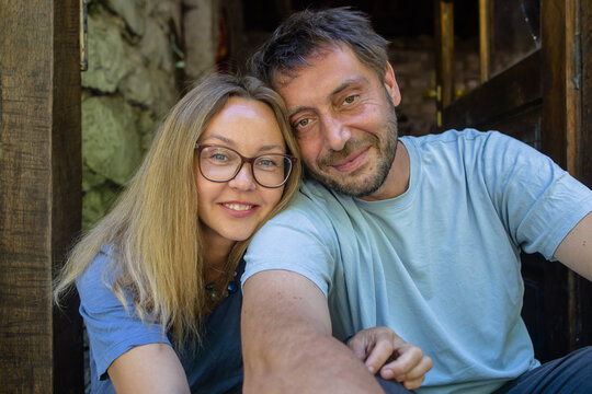 Portrait of a couple on the doorstep of an old stone house