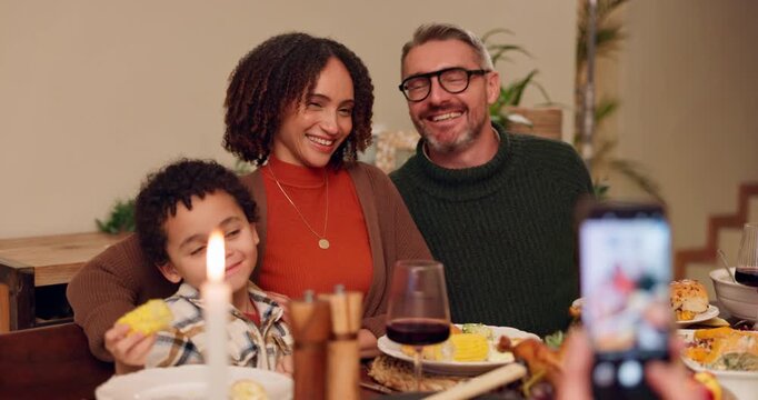 Food, photograph and smile with family at dining room table of home together for thanksgiving celebration. Bonding, love or memory with mother, father and son taking picture in apartment at night