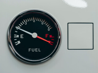Crisp high-quality photo of a circular fuel gauge showing a full tank, automotive dashboard detail