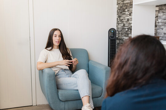 Young woman talking at the psychologist.