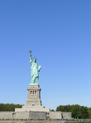 Fototapeta premium Lady Liberty sun soaking in New York City