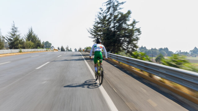 A high performance athlete riding a bicycle on a road