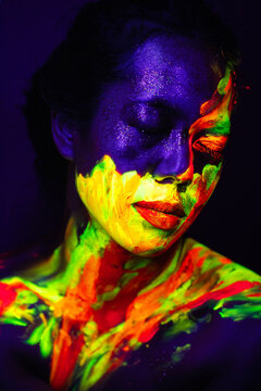 Person with Neon Abstract Face and Body Paint