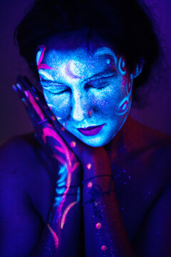 Person with Fluorescent Face Paint Under Blacklight