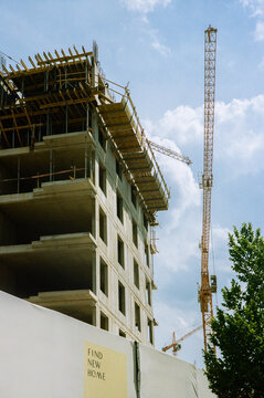Construction crane near building against the blue sky