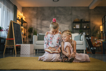 older friend sister help her young friend sister to read a book