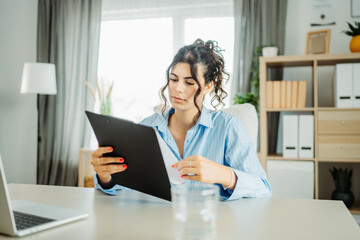 Young caucasian business woman working in office on laptop