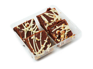A tray of chocolate covered cake with nuts on white background. The tray is divided into four sections. The chocolate is drizzled over the nuts, giving them a delicious and appetizing appearance