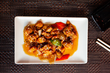 Traditional Japanese cuisine. Chicken teriyaki with bell pepper on white plate
