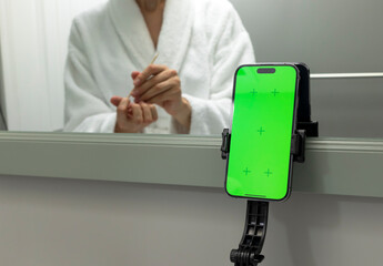 White Woman Holds Wooden Cuticle Pusher Stick And Green Chroma Key Screen On Smartphone, E-learning...