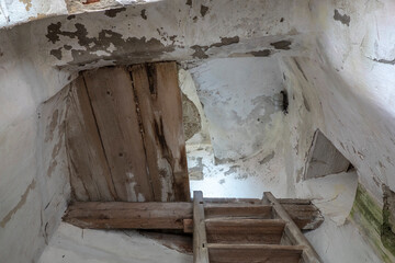 Wooden steps in the tower of an old working belfry leading to the bell at the top of the tower