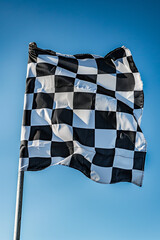 Checkered flag isolated on blue sky. High quality photo