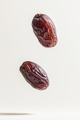 Barhi Dates fruit levitating on a white background