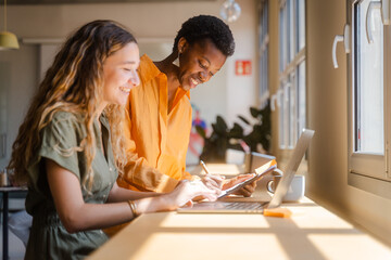 Diverse Businesswomen Working Together In Modern Workplace