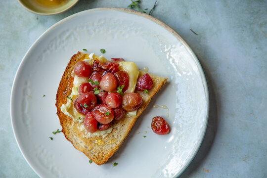 Roasted grapes and brie on toast with honey.