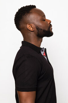 Side profile of a black man with a beard and short hair