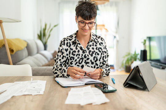 Accountant woman making monthly accounts with receipts