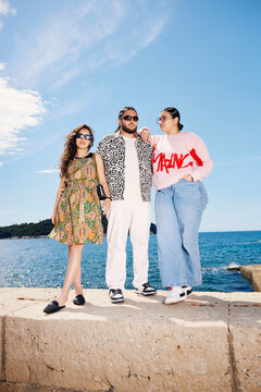 Friends standing at the breakwater