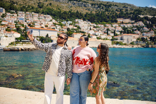 Friends takes selfie by the sea