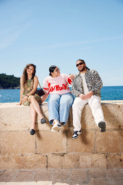 Friends sitting at the breakwater