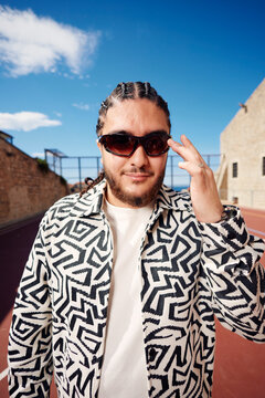 Smiling man with cornrows in the old town