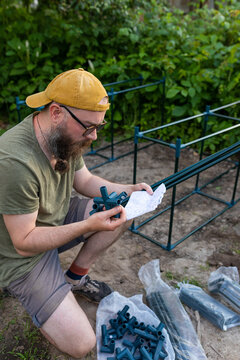 man reading instructions for a greenhouse