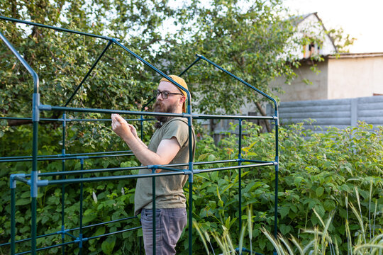 man in frame greenhouse