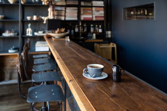 Cup Of Coffee With Milk On The Bar Table In Restaurant