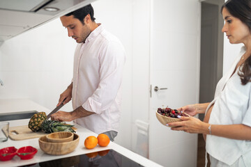 pregnant woman with husband doing daily chores at home