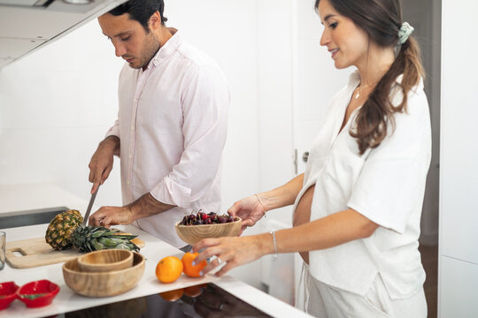 pregnant woman with husband doing daily chores at home
