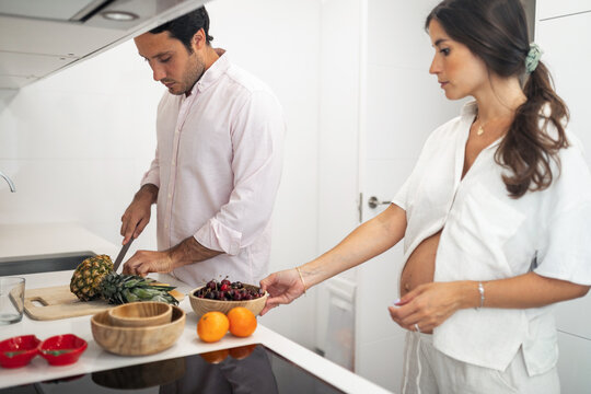 pregnant woman with husband doing daily chores at home