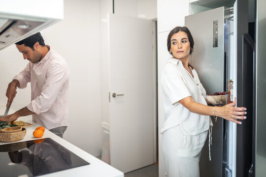 pregnant woman with husband doing daily chores at home