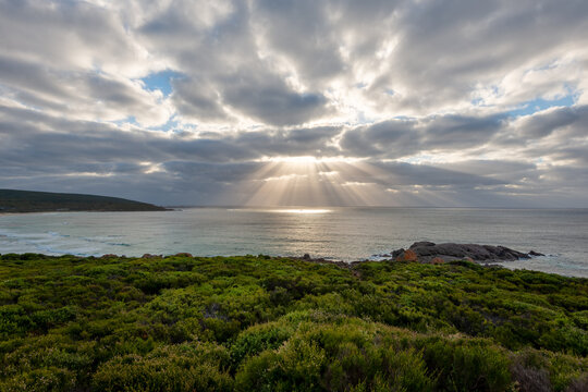 Late afternoon god rays of light over ocean 