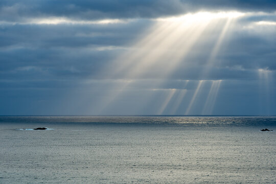 Late afternoon god rays of light over ocean 