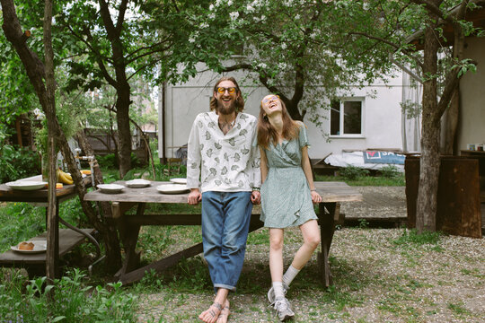 a young couple in the yard near the buffet table