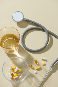 Healthcare Concept with Pills, Stethoscope, and Glass of Water