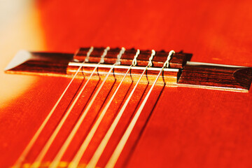  Detailed acoustic guitar focusing on the strings and body. Wooden guitar neck with the strings...