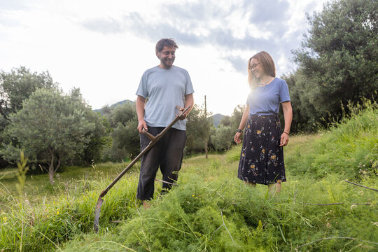 Woman and man on the hayfield