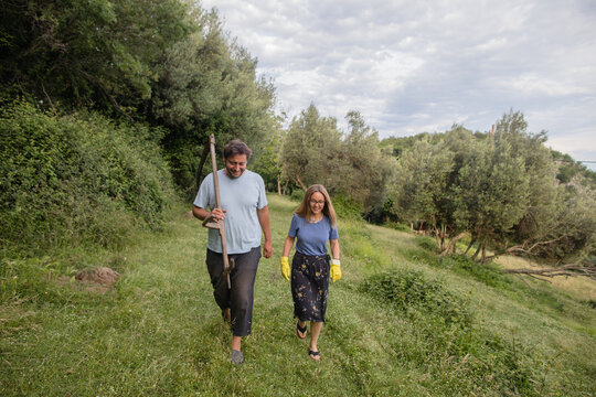 Man and woman going to haymaking