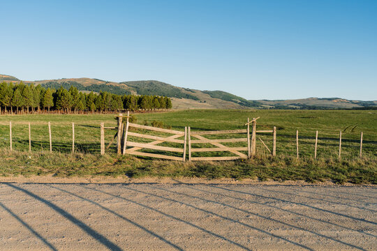 Wooden gate by field