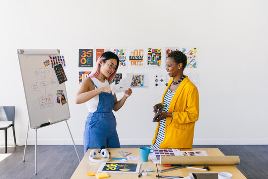 Creative brainstorming session with two designers in modern workspace