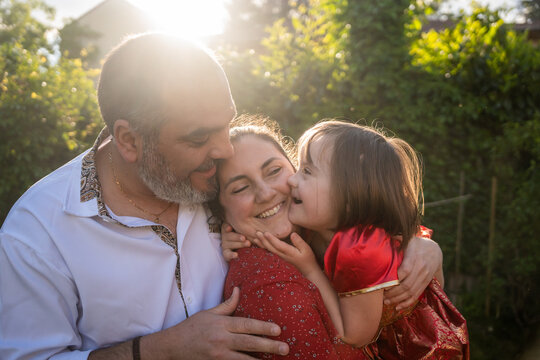 Family Hugging In Garden