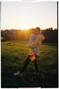 Mother holding her son at sunset in zakopane