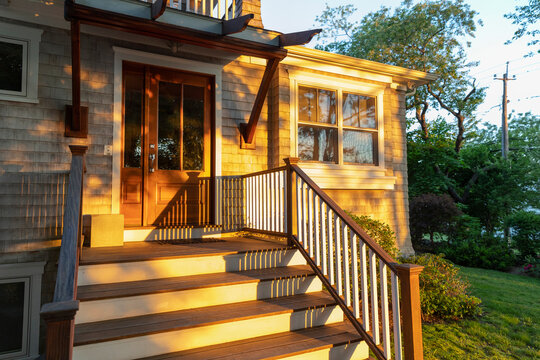 Side angle Front Door of Home with Sunrise light on wooden door 