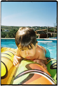 Young Boy Relaxing on Inflatable Raft