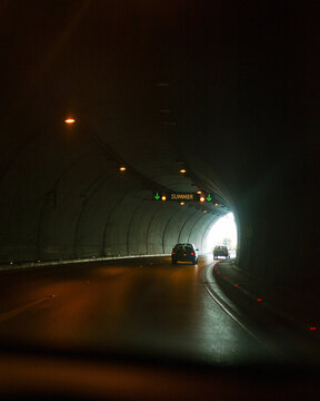 Passenger cars pull out of the dark tunnel