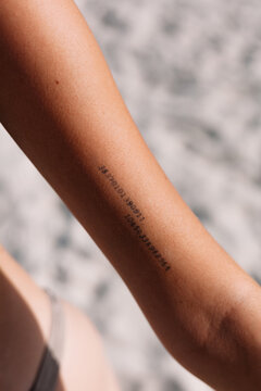 Crop person with tattoo with digits on arm