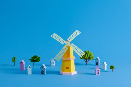 Colorful Paper Windmill With Houses And Trees